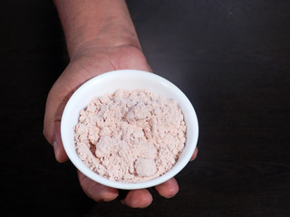 Black Salt in White Bowl on Hand, Black Salt on Wooden Background, Black Salt Called Kala Namak in India,Salt, Black Salt in Good for Our Health