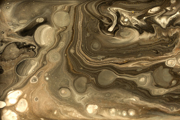 Gold marbling texture design. Beige and golden marble pattern. Fluid art.