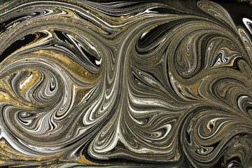 Gold marbling texture design. Black and golden marble pattern. Fluid art.