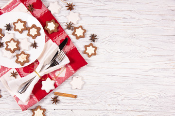 Holiday concept with napkin, cutlery, cookies and spices