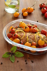 Baked chicken breast with cherry tomatoes in baking dish