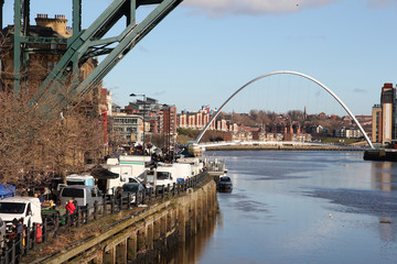 The Tyne and Millennium bridges of Newcastle-Upon-Tyne with the busy sunday market taking place on...