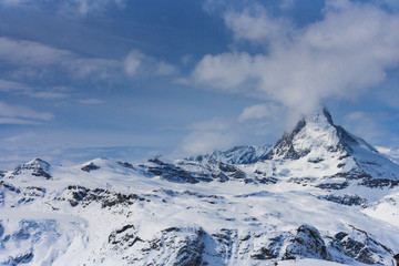 Obraz premium The famous mountain Matterhorn peak with cloudy and blue sky from Gornergrat, Zermatt, Switzerland