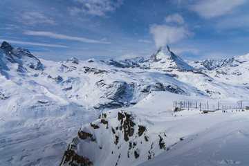 Obraz premium The famous mountain Matterhorn peak with cloudy and blue sky from Gornergrat, Zermatt, Switzerland
