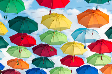Fototapeta na wymiar hanging colorful umbrellas on a sunny day