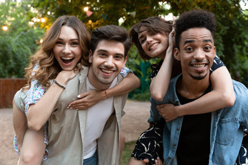 Group of young friends party outdoors in park having fun.