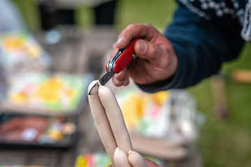 Sausages are prepared for cooking on the grill.