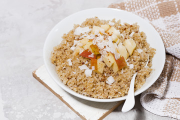 quinoa with apple and coconut for healthy breakfast, top view