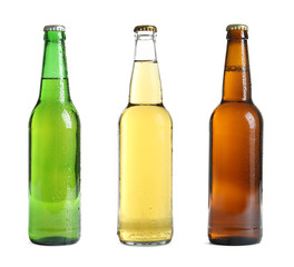 Set with different cold beer bottles on white background