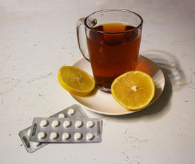 Tea lemon pills on white table