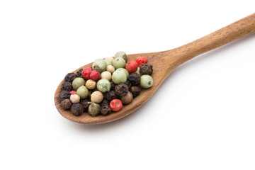 Pepper mix seed on spoon on white background.