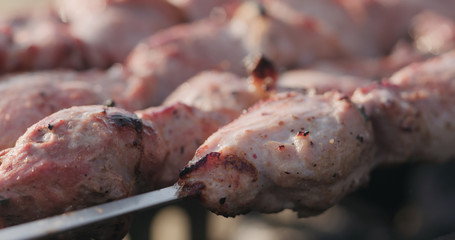 closeup cooking pork shashlik on skewers outdoor