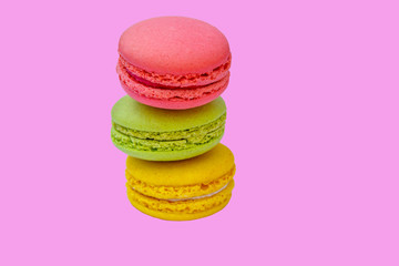 Tasty colorful macaroons on pink background