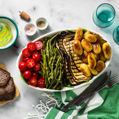 a side dish of vegetables on the holiday table. healthy food for the whole family or dinner at a...
