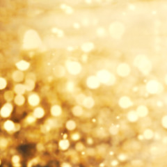 Fototapeta premium Golden blur soft abstract Christmas background with bokeh. Merry Christmas blurred beautiful shiny lights