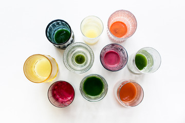 cups of freshly pressed juice on white background