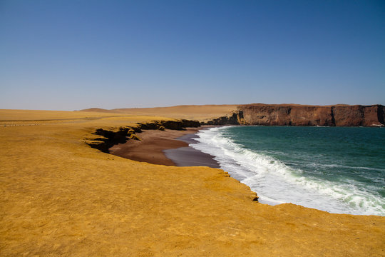 red sand beach in paracas national reserve Peru