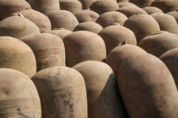 Fototapeta na wymiar ceramic barrels of peruvian pisco wine production, close up
