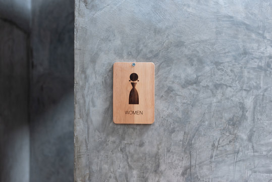 femel toilet sign on wood
