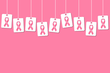 Breast cancer awareness background with hanging pink ribbon tags or cards on a pink background and space for text and headline. Pink ribbon cover template.