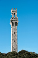 Fototapeta premium A tower with architectural elements of European design sits atop a hill 