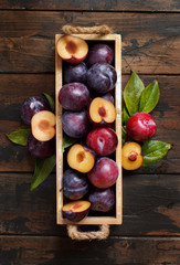 Fresh plums with leaves