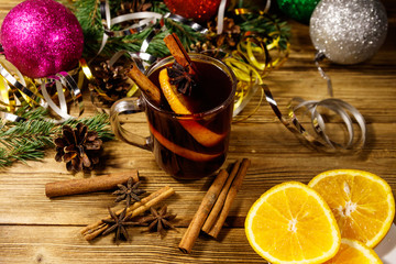 Christmas mulled wine with spices and Christmas decoration on wooden table