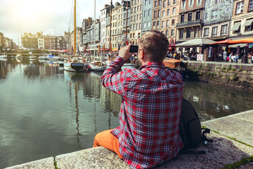 Fototapeta na wymiar man taking a shot of Honfleur harbor