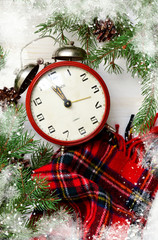 Fototapeta na wymiar Christmas background with a clock and Christmas tree with a place for the text. Xmas greeting card.