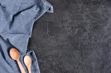 Background with blue denim napkin on the dark gray textured table