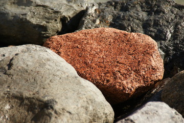 Red stone on Malta beach Valetta during vacation on the island