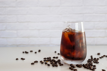 a glass of homemade cold cold brew coffee on white table background