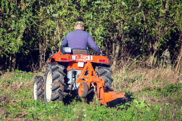 Obraz premium Tractor plowing fields -preparing land for sowing