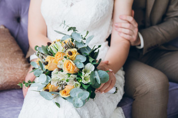 Wedding bouquet in the hands of the bride