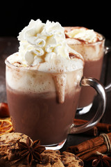 Hot chocolate cocoa with whipped cream on table.