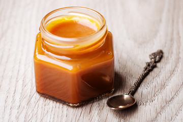 Salted caramel sauce in a glass jar 