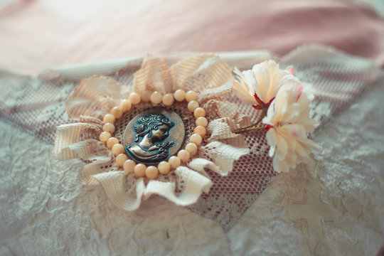 Delicate composition with old brooch decorated in rustic style