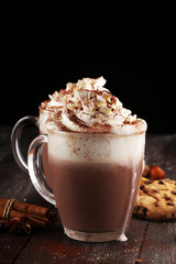 Hot chocolate cocoa with whipped cream on table.
