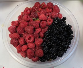 Raspberries and blaclberries in bowl