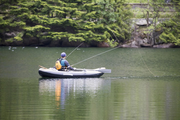 Fototapeta na wymiar men fishing in kayak