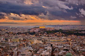 Fototapeta na wymiar Illuminated Acropolis of Athens Greece at cloudy sky
