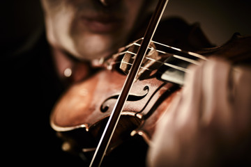 Violint play music on dark background musician