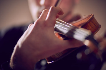 Violint play music on dark background musician
