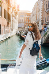 Fototapeta na wymiar Young girl posing on camera in venetian streets
