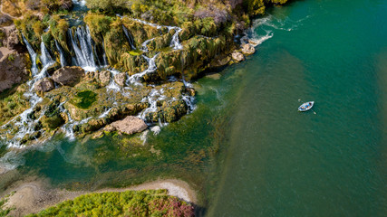 Beautiful water fall on the Snake River with a drift boat filled with fisherman © knowlesgallery