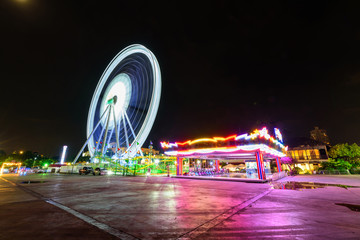 Ferris wheel at amusement park in sunset time / Moving of Ferris wheel at amusement park