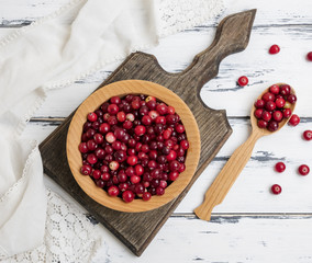 red berries of ripe lingonberries in a wooden bowl