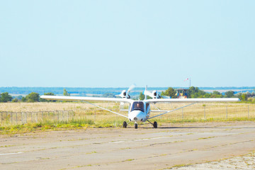 Light private twin-engined aircraft plane on the runway