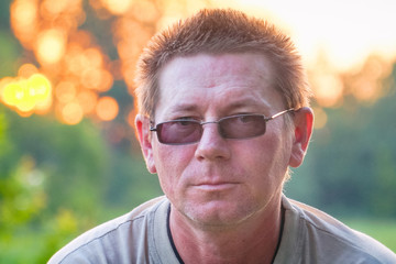 Portrait of a man in dark glasses with sloppy hair