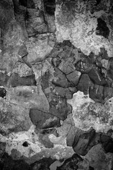Peeling paint on a cement wall. Abstract texture background. Black and white photo